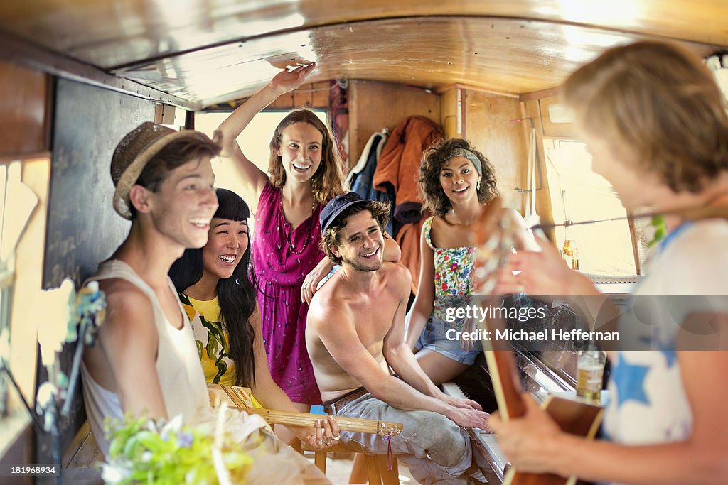 Young people party inside canal boat