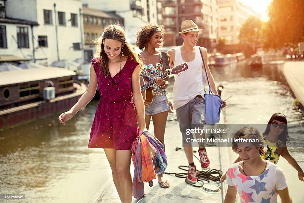 Young people walking on top of canal boat