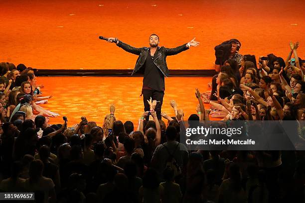 Guy Sebastian performs during the Nickelodeon Slimefest 2013 matinee show at Sydney Olympic Park Sports Centre on September 27, 2013 in Sydney,...