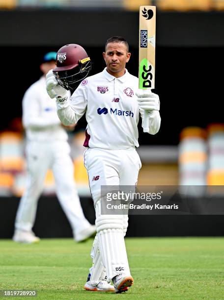 Usman Khawaja of Queensland celebrates after scoring a century during day two of the Sheffield Shield match between Queensland and Western Australia...