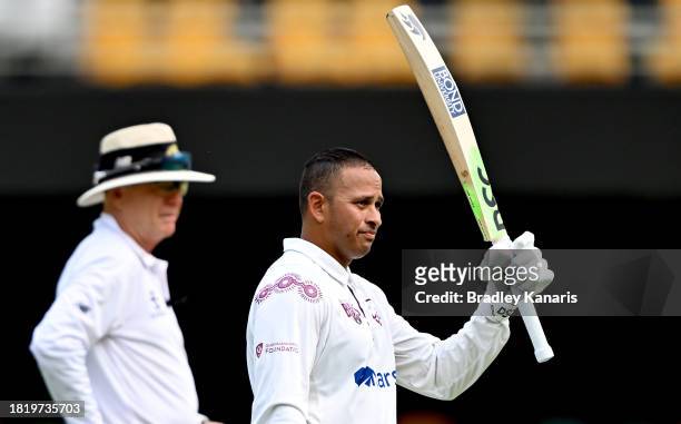 Usman Khawaja of Queensland celebrates after scoring a century during day two of the Sheffield Shield match between Queensland and Western Australia...