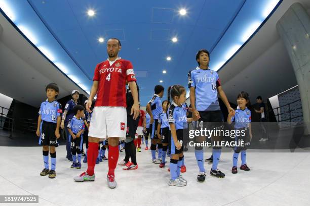 Captains Marcus Tulio Tanaka of Nagoya Grampus and Kengo Nakamura of Kawasaki Frontale lead the team in the tunnel prior to the J.League J1 second...