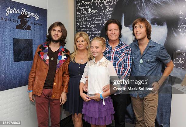 Tyler Fogerty, Julie Fogerty, Kelsy Fogerty, John Fogerty and Shane Fogerty pose in the John Fogerty: Wrote A Song For Everyone exhibit during a...