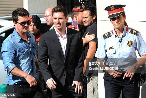 Barcelona football star Lionel Messi and his brother Rodrigo arrive to the courhouse in the coastal town of Gava near Barcelona on September 27, 2013...