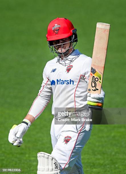 Jake Fraser-McGurk of the Redbacks raises his bat as he leaves the ground after getting out to Fergus O'Neill of the Bushrangers for 101 during the...
