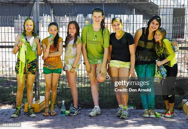 Participants pose outside after being covered in slime during the Nickelodeon Slimefest 2013 matinee show at Sydney Olympic Park Sports Centre on...