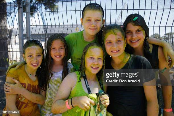 Participants pose outside after being covered in slime during the Nickelodeon Slimefest 2013 matinee show at Sydney Olympic Park Sports Centre on...