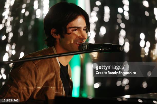 Max Ehrich performs onstage during a Holiday Celebration with the Stars of "It's A Wonderful Lifetime", joining together to honor military spouses...