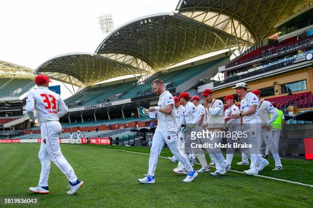 Jake Lehmann captain of the Redbacks leads his team out to start the last session during the Sheffield Shield match between South Australia and...