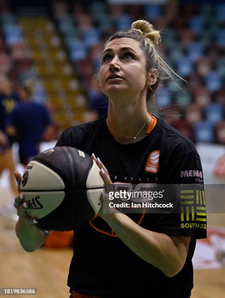 Cassandra Brown of the Fire warms up before the start of the WNBL match between Townsville Fire and Adelaide Lightning at Townsville Entertainment...