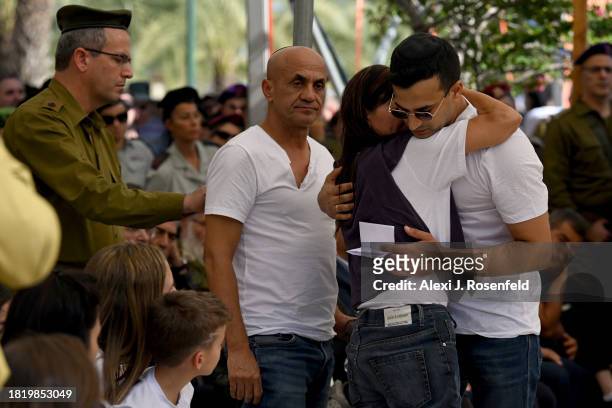 The brother of Col. Asaf Hamami, commander of Gaza Division’s Southern Brigade, hugs their mother next to their father during his funeral at the...