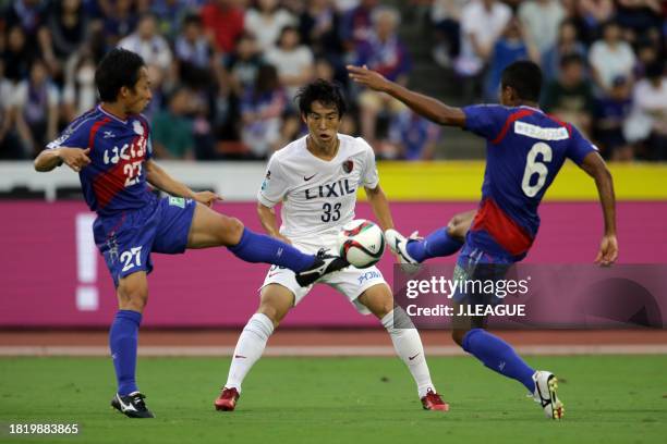 Mu Kanazaki of Kashima Antlers competes for the ball against Shohei Abe and Marquinhos Parana of Ventforet Kofu during the J.League J1 second stage...