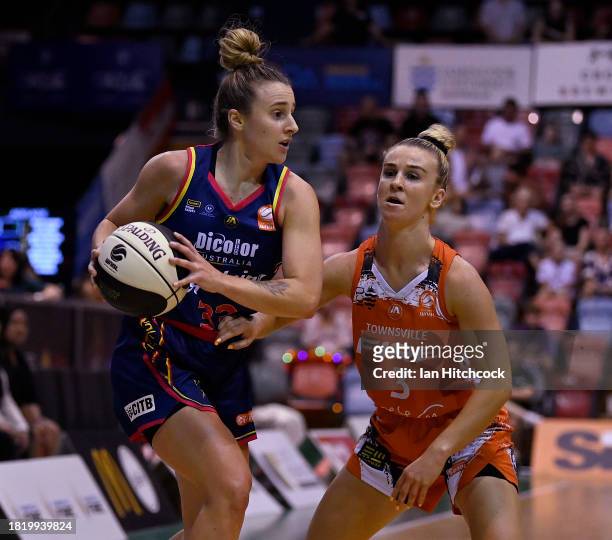 Lauren Mansfield of the Lightning looks to get past Steph Reid of the Fire during the WNBL match between Townsville Fire and Adelaide Lightning at...