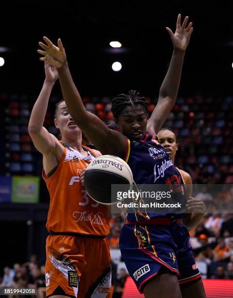 Jocelyn Willoughby of the Lightning is blocked during the WNBL match between Townsville Fire and Adelaide Lightning at Townsville Entertainment...