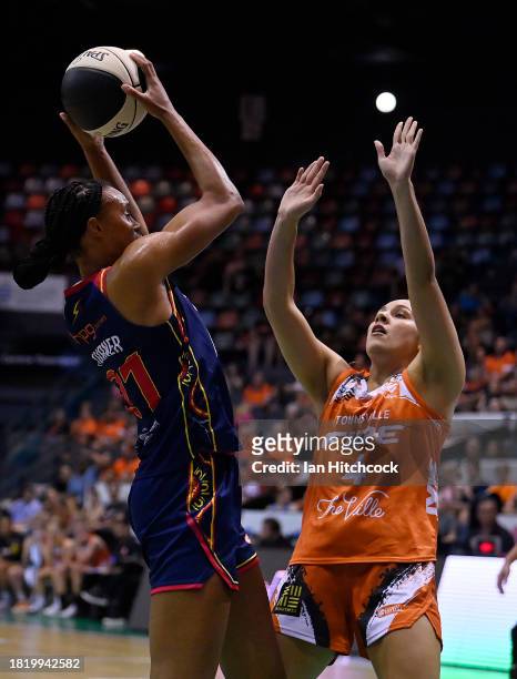 Brianna Turner of the Lightning takes a shot over Jessica McDowell-White of the Fire during the WNBL match between Townsville Fire and Adelaide...