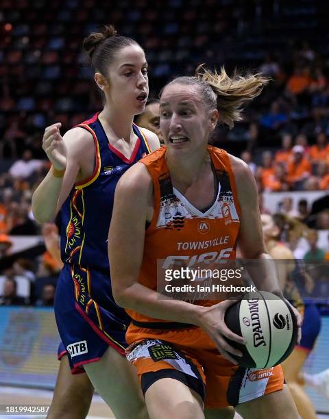 Mikaela Ruef of the Fire collects a rebound during the WNBL match between Townsville Fire and Adelaide Lightning at Townsville Entertainment Centre,...