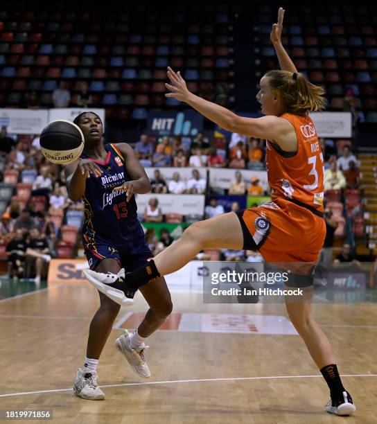 Jocelyn Willoughby of the Lightning gets a pass away past Mikaela Ruef of the Fire during the WNBL match between Townsville Fire and Adelaide...