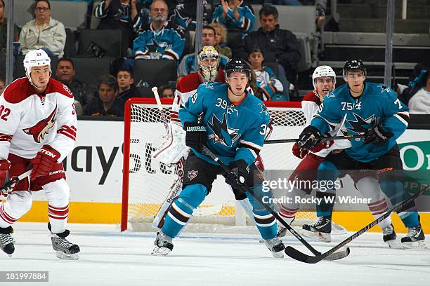 Harri Sateri and Freddie Hamilton of the San Jose Sharks skate into position against Brandon Yip and Brandon Gormley of the Phoenix Coyotes during a...