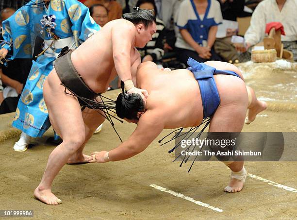 Mongolian yokozuna Hakuho , whose real name is Mnkhbatyn Davaajargal throws ozeki Kotoshogiku during day twelve of the Grand Sumo Autumn Tournament...