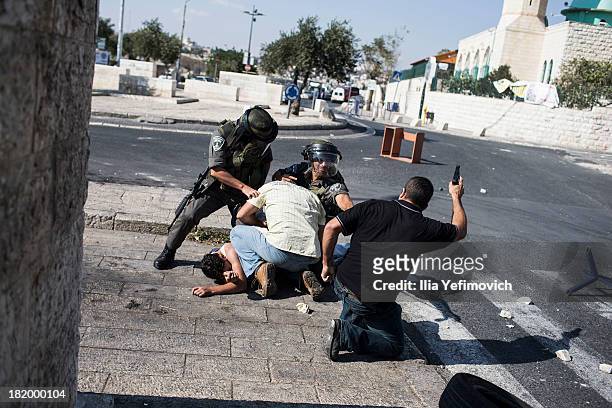 Israeli border policemen and undercover police arrests a Palestinian youth during clashes with Police after friday prayers on September 27, 2013 in...