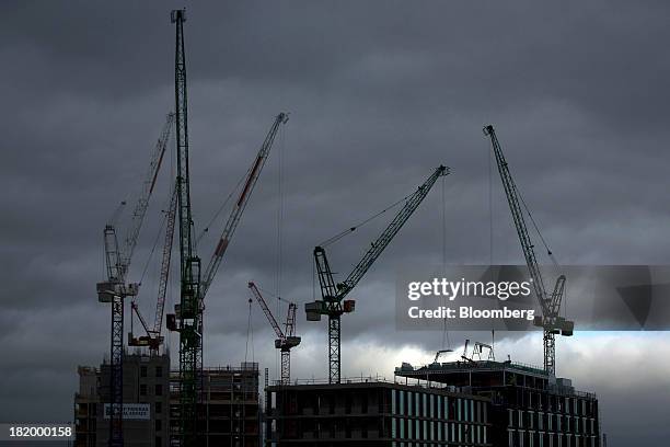Construction cranes stand above a new commercial real estate development near Kings Cross rail station in London, U.K., on Thursday, Sept. 26, 2013....