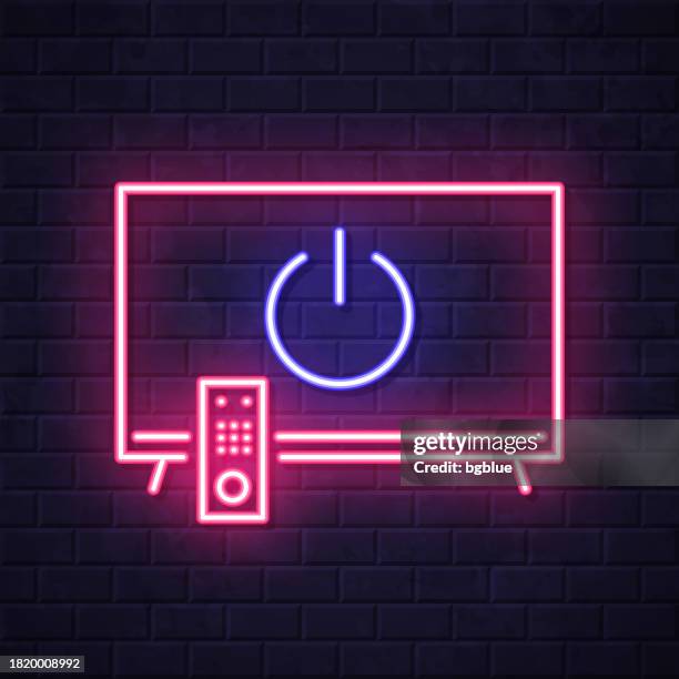 tv with power button. glowing neon icon on brick wall background - start or stop button stock illustrations