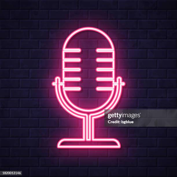 mikrofon. leuchtende neon-ikone auf backsteinwandhintergrund - mikrofonständer stock-grafiken, -clipart, -cartoons und -symbole