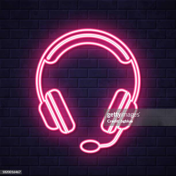 headset. glowing neon icon on brick wall background - dj console stock illustrations