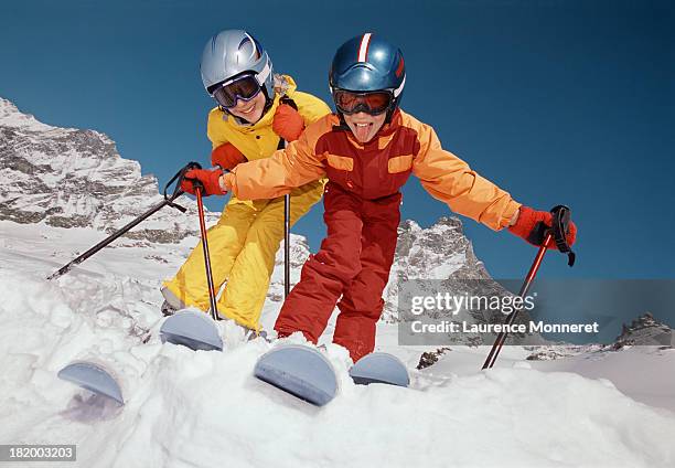 smiling kids playing at ski in snow - funny snow skiing stock pictures, royalty-free photos & images