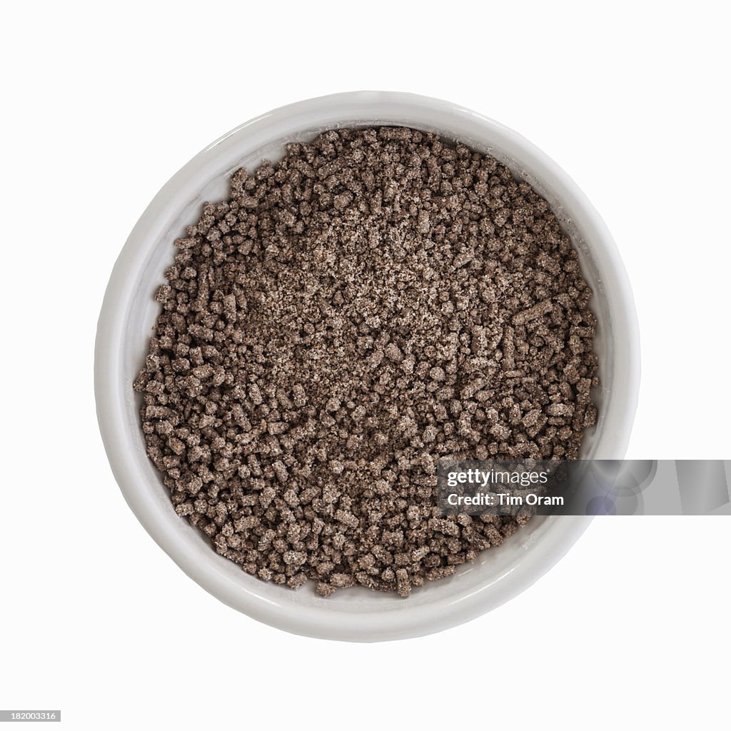 A bowl of gravy granules on white