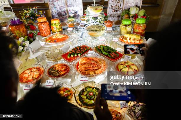 Visitors look at various kinds of kimchi exhibited at the National Kimchi Show at the Food Festival House on Ryomyong Street, Pyongyang on December...