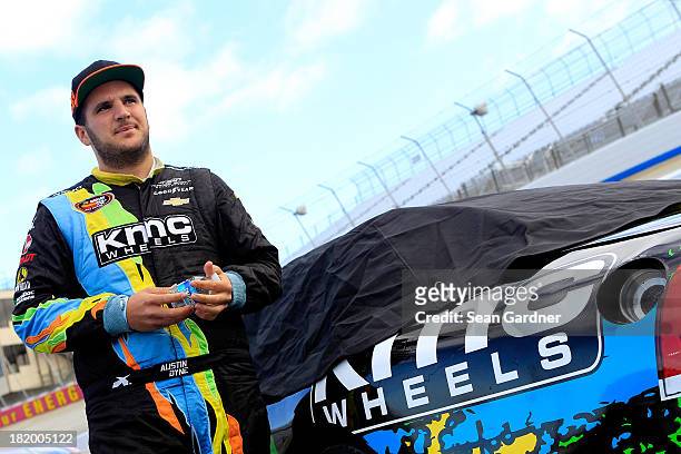 Austin Dyne, driver of the KMC Wheels Chevrolet, stands on the grid during qualifying for the NASCAR K&N Pro Series East Drive Sober 150 at Dover...