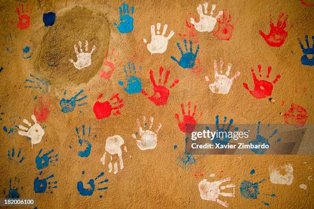 Wall with red, blue, and white handprints on February 1, 2005 in the Moroccan Atlas Mountains, Morocco