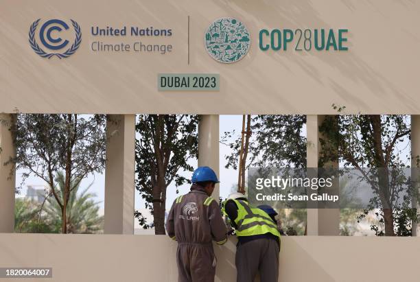 Workers prepare a riser at the UNFCCC COP28 Climate Conference the day before its official opening on November 29, 2023 in Dubai, United Arab...
