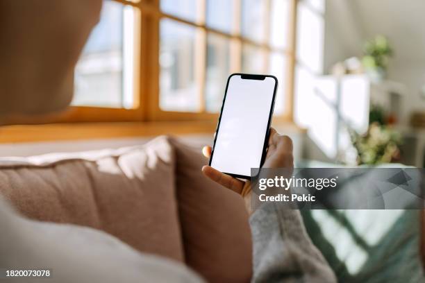 woman using a smart phone with blank screen - telephone stock pictures, royalty-free photos & images