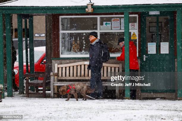 Members of the public make their way through the snow on November 29, 2023 in Ballater Scotland. On Tuesday, the Met Office issued a warning for snow...