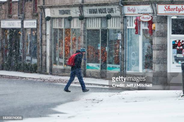 Members of the public make their way through the snow on November 29, 2023 in Ballater Scotland. On Tuesday, the Met Office issued a warning for snow...