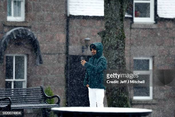 Members of the public make their way through the snow on November 29, 2023 in Ballater Scotland. On Tuesday, the Met Office issued a warning for snow...
