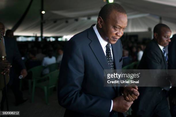 Kenyan President Uhuru Kenyatta takes part in the funeral service for his nephew Mbugua Mwangi and his fiancee Rosemary Wahito who were killed at the...