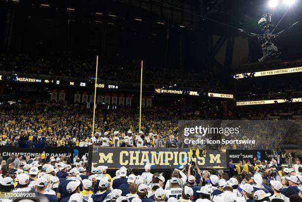 The Michigan Wolverines celebrate after the Big 10 Championship game between the Michigan Wolverines and Iowa Hawkeyes on December 2 at Lucas Oil...