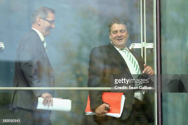 Sigmar Gabriel , Chairman of the German Social Democrats , and SPD member Matthias Platzeck walk across a glassed-in bridge at SPD headquarters to a...