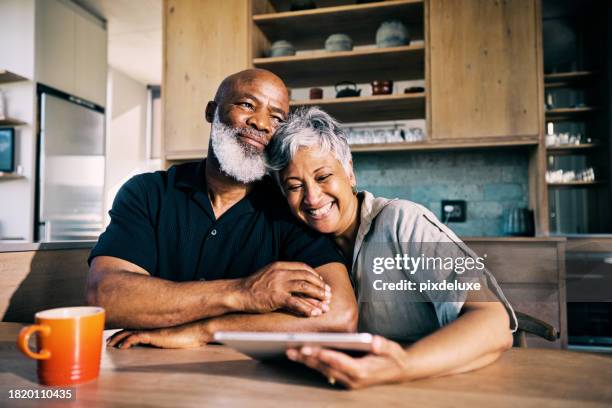 senior african-american couple happy with their retirement plans - couple investing stock pictures, royalty-free photos & images