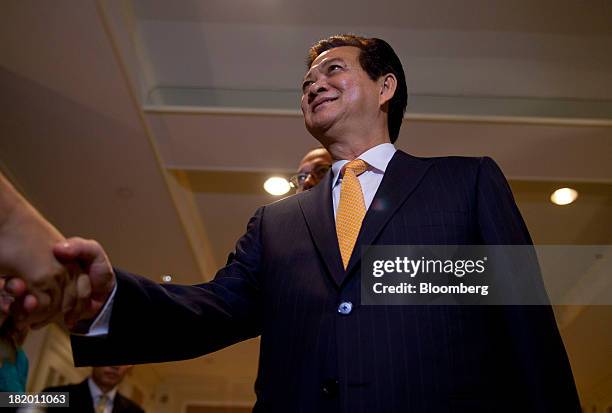 Nguyen Tan Dung, Vietnam's prime minister, greets members of the media before an interview in New York, U.S., on Friday, Sept. 27, 2013. Vietnams...