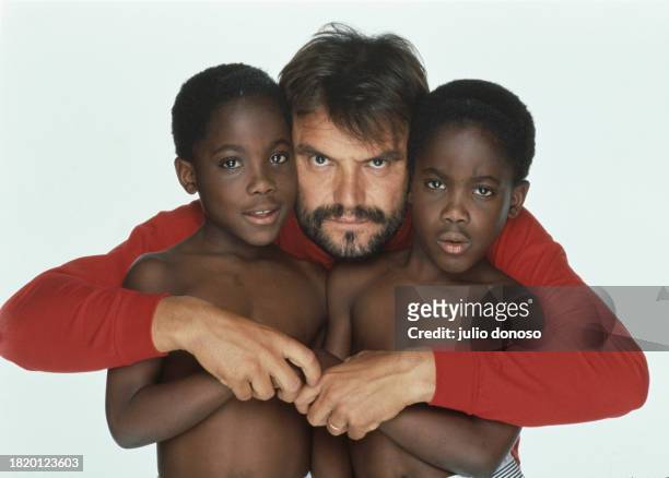 Italian photographer Oliviero Toscani photographs a group of children who are wearing Benetton clothing. Toscani began his collaboration with the...