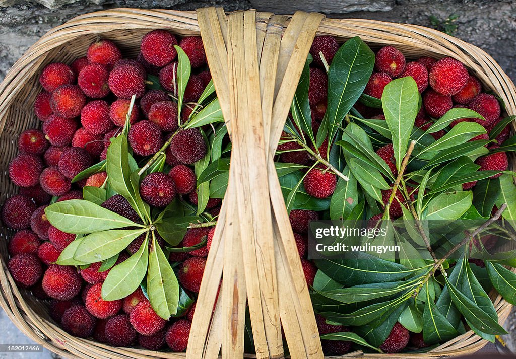 A bamboo basket of waxberries for sale