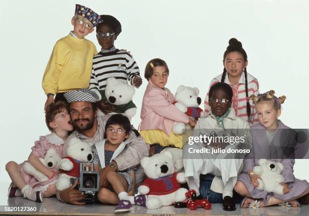 Italian photographer Oliviero Toscani photographs a group of children who are wearing Benetton clothing. Toscani began his collaboration with the...