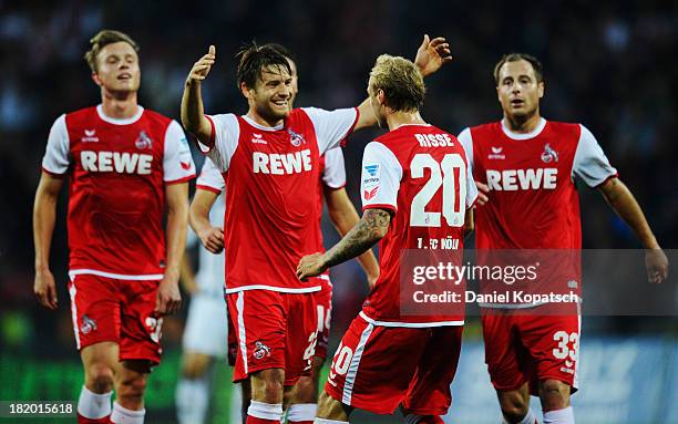 Marcel Risse of Koeln celebrates his team's first goal with team mates during the second Bundesliga match between VfR Aalen and 1. FC Koeln at...