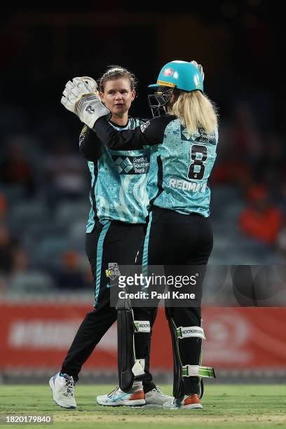 Jess Jonassen and Georgia Redmayne of the Heat celebrate the wicket of Nat Sciver-Brunt of the Scorchers during The Challenger WBBL finals match...