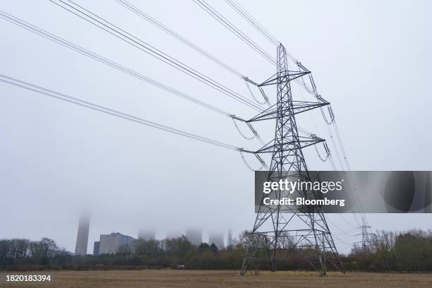 Electricity pylons pass the four southern cooling towers at the decommissioned Fiddler's Ferry coal fueled power station in Warrington, UK, on...