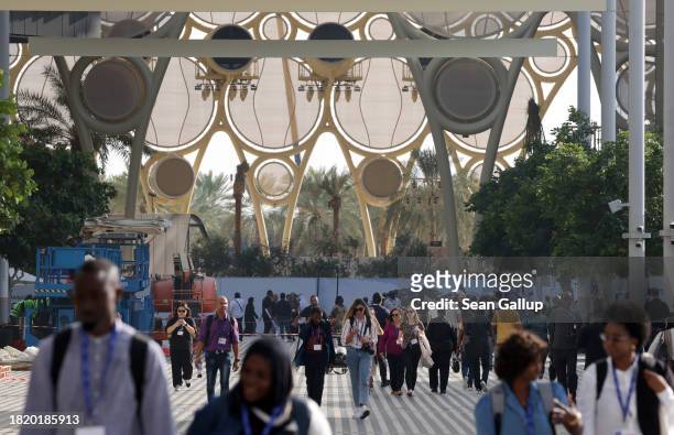 People walk outside at the venue of the UNFCCC COP28 Climate Conference the day before its official opening on November 29, 2023 in Dubai, United...